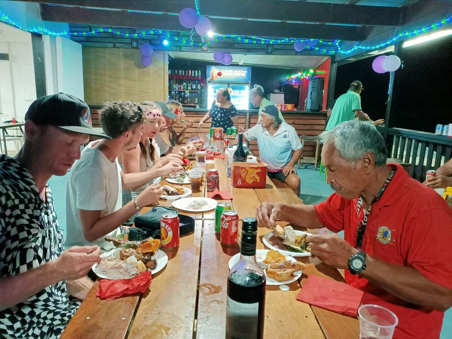 a group of people eating at a restaurant