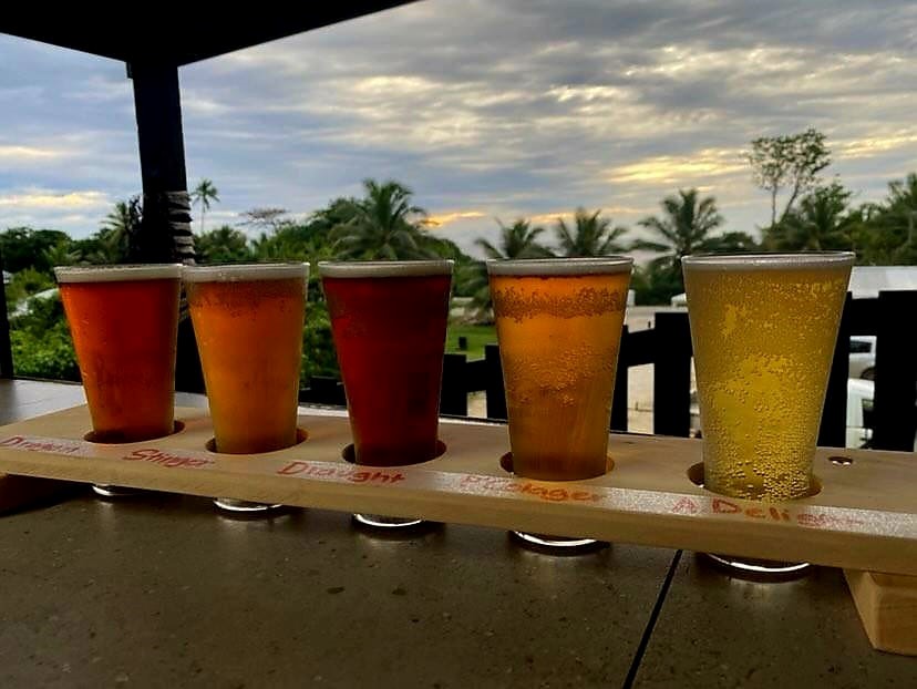 a group of tasting glasses with beer in them