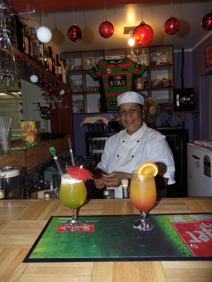 a person sitting at a table with drinks on it