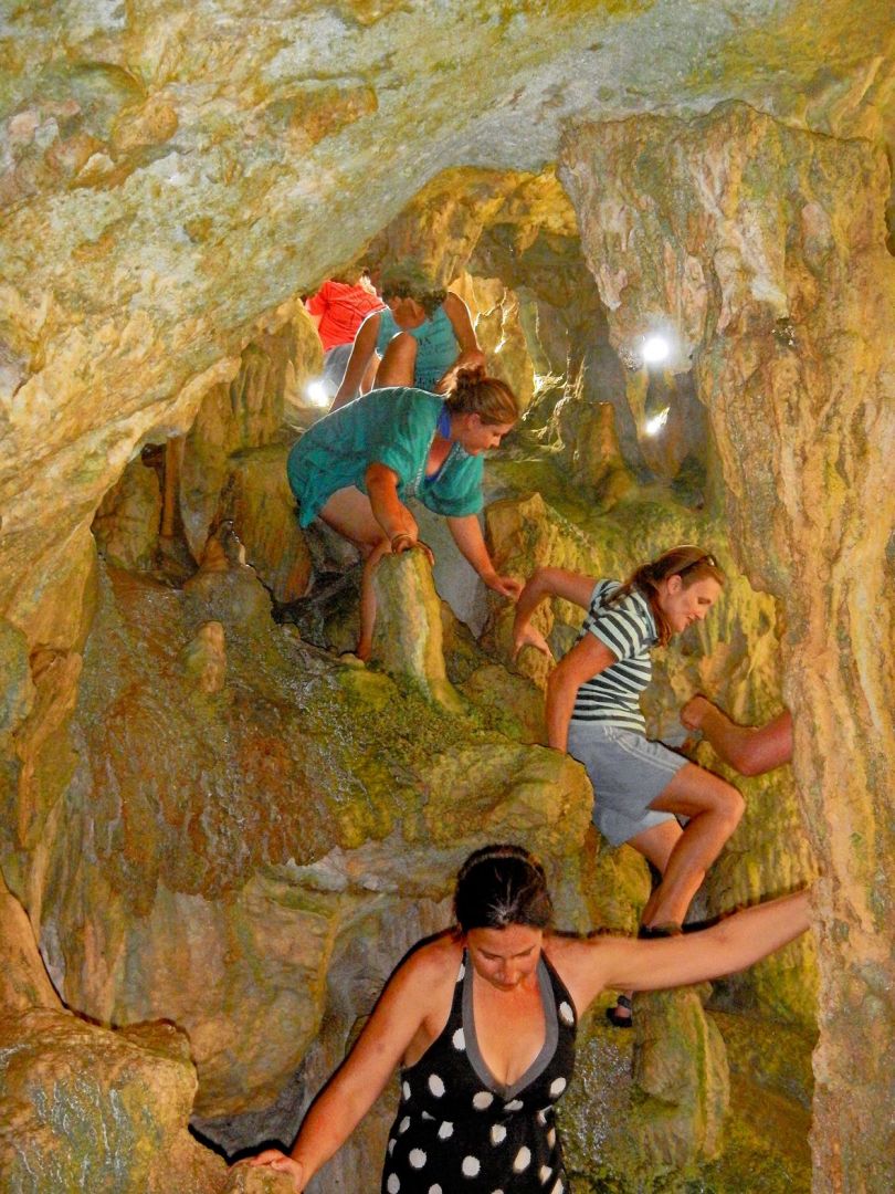 a group of people climbing a rock wall