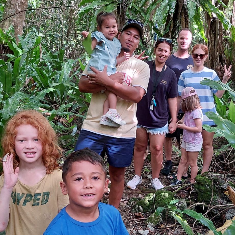 a group of people posing for a photo in forest