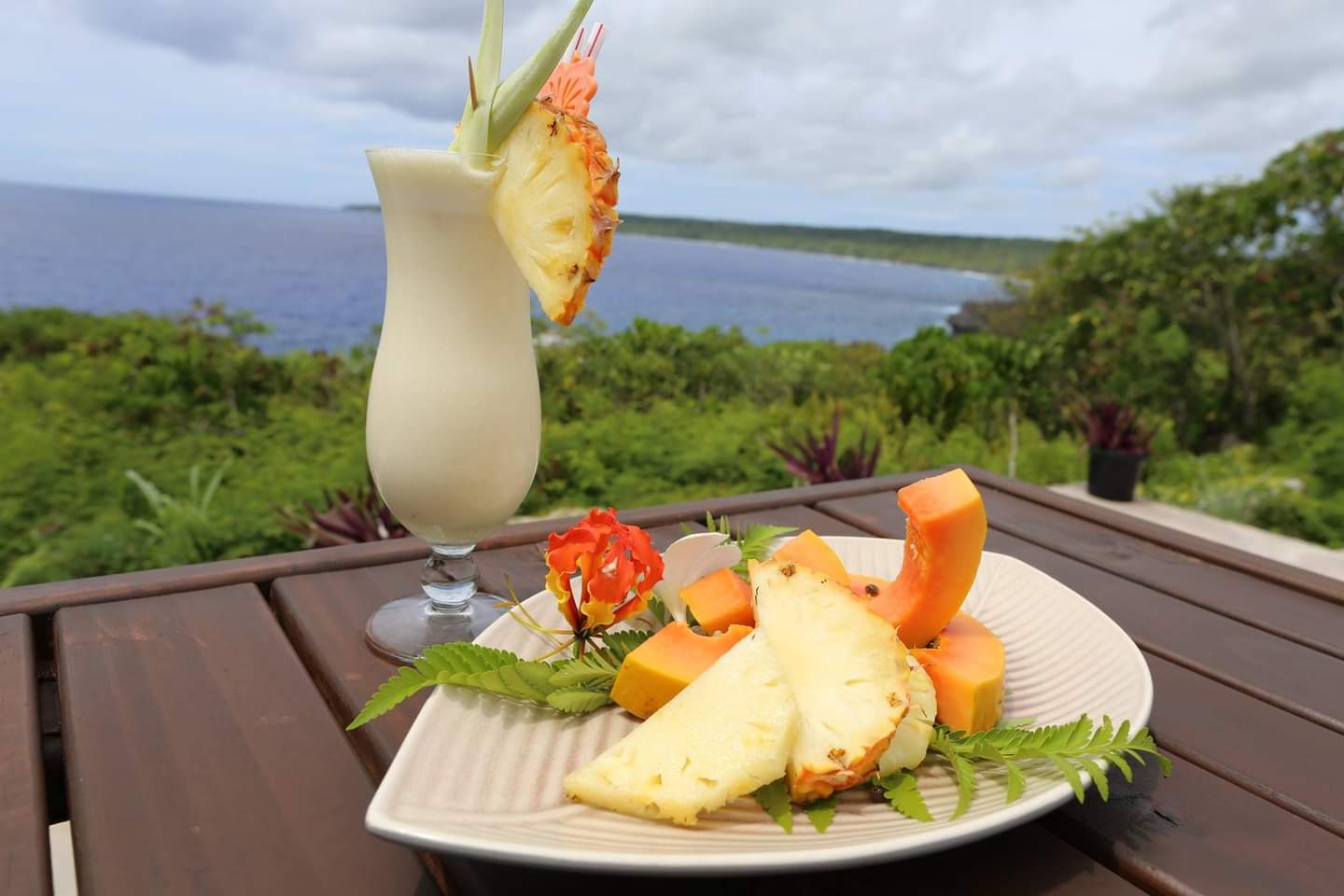 a plate of fruit and a glass of milk on a table