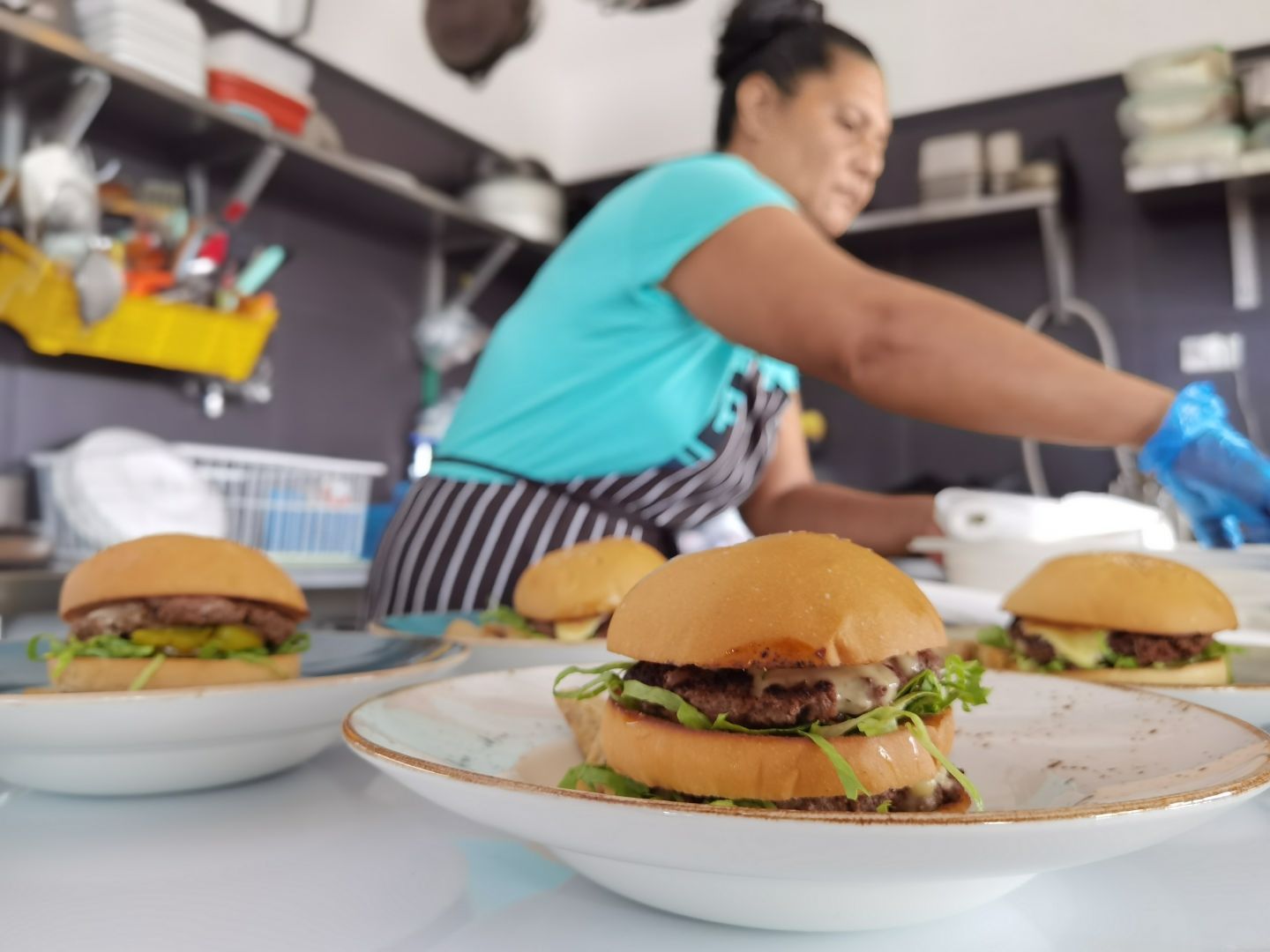 a woman preparing a sandwich