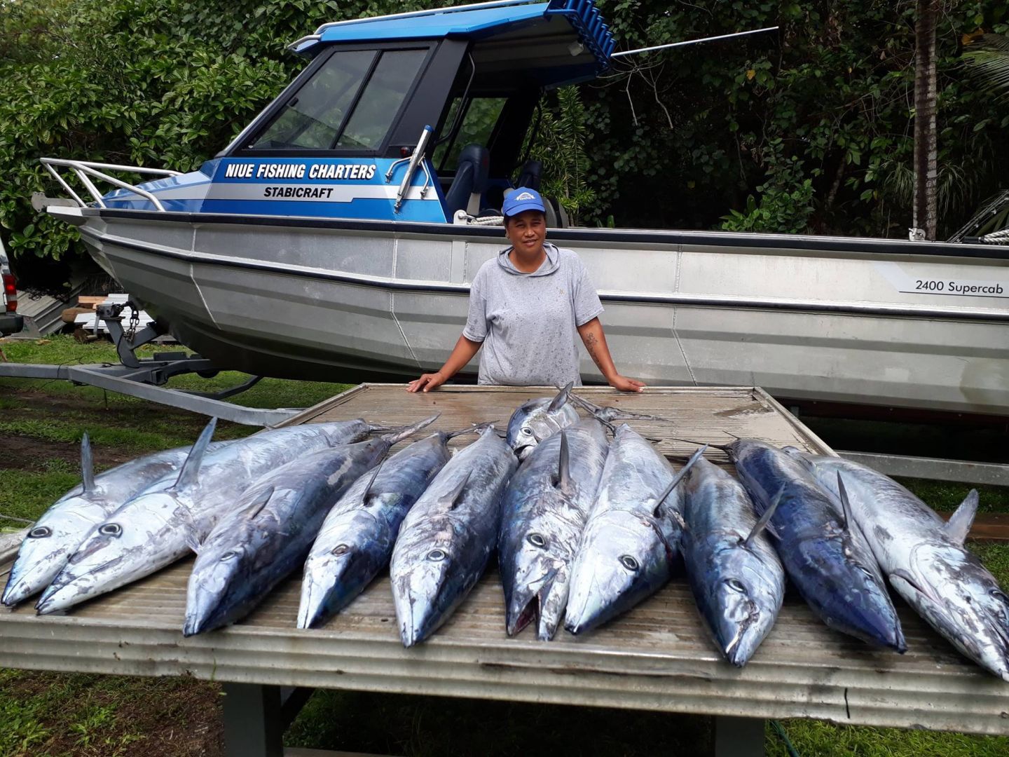 man with fishing boat and lots of big fish