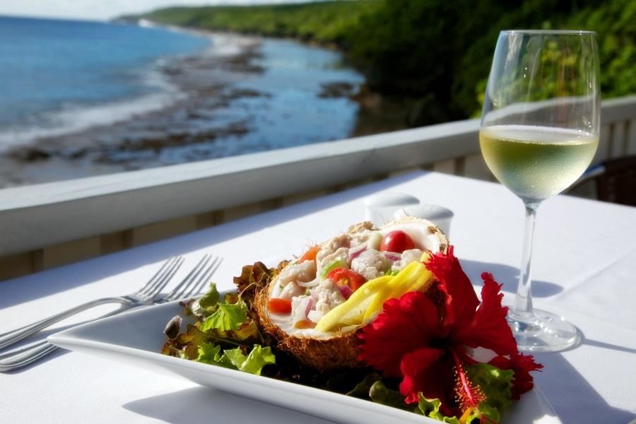 a plate of food and a glass of wine on a table