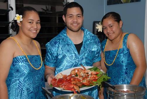 a group of people holding a plate of food