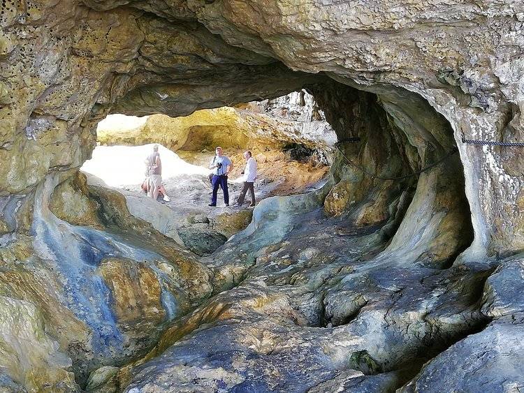 people standing in a cave