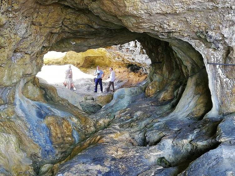 people standing in a cave