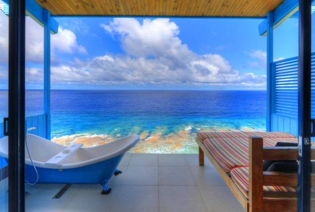 a pool and a deck overlooking the ocean