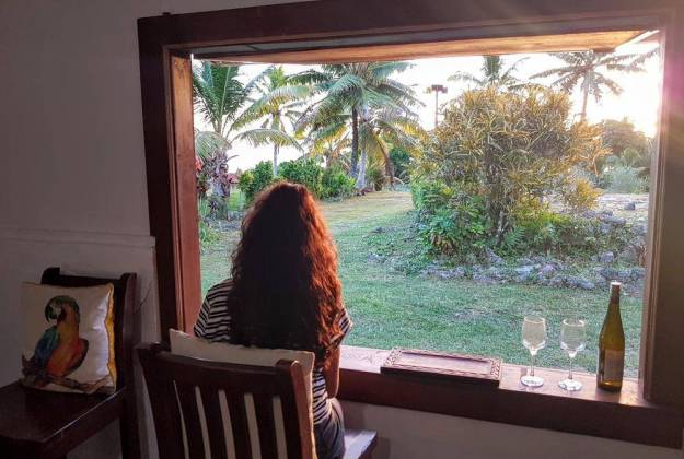 a person sitting at a table looking out a window