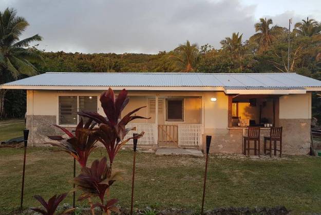 a house with a fence and trees in the back