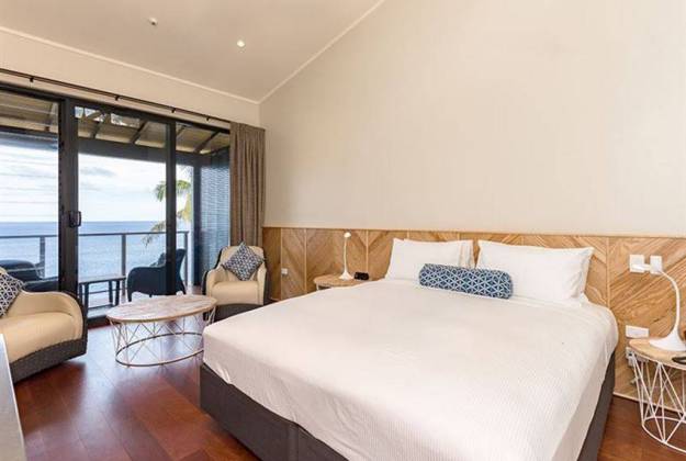 room with white bed and sliding doors at Scenic Matavi Resort