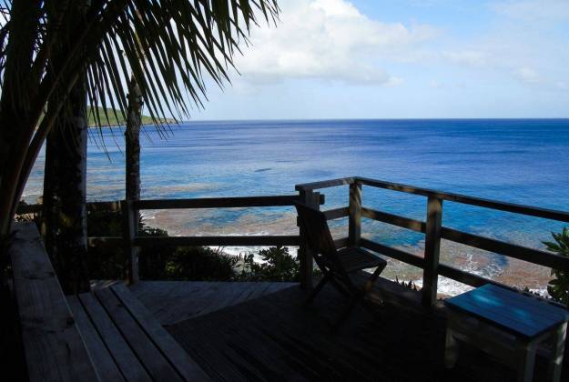 a wooden deck overlooking a body of blue water