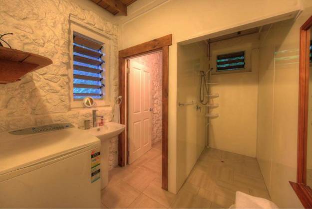 a bathroom with a sink and a shower unit