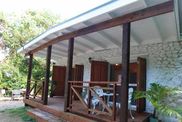 a wood deck with a wood railing and a wood railing with trees in the background