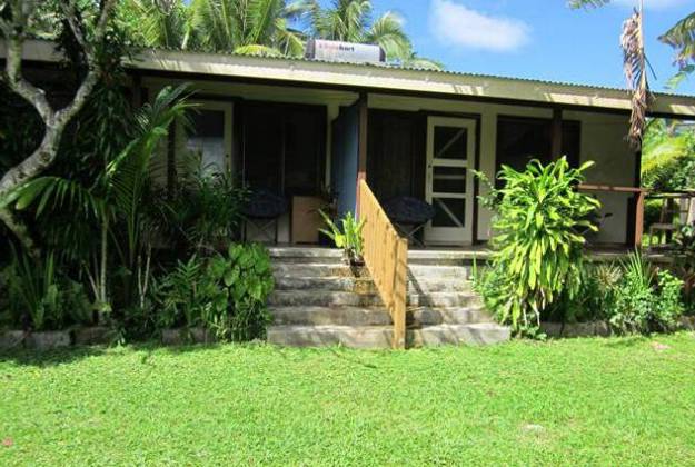 a house with a staircase and grass