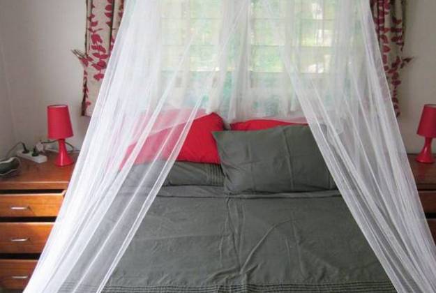 a bed with a white curtain