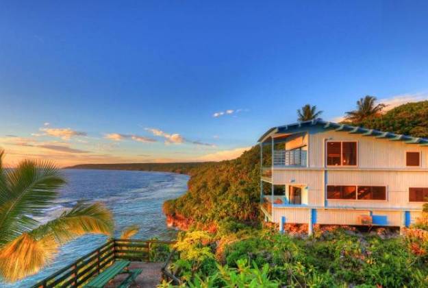 a house on a hill by the water