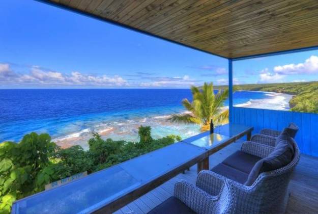 a deck overlooking a beach at Lau's Getaways