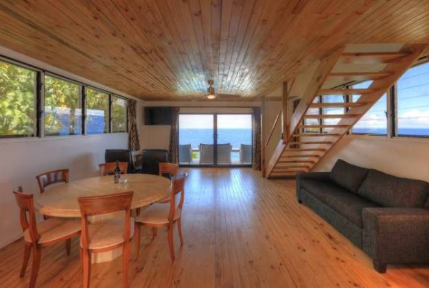 a living room with a wood floor at Lau's Getaways