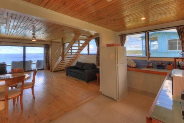 a living room with a staircase at Lau's Getaways