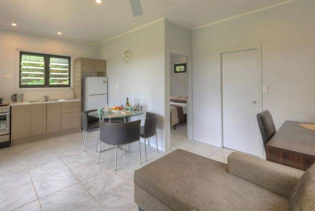 a kitchen with living room at the accommodation of Petite Hatava