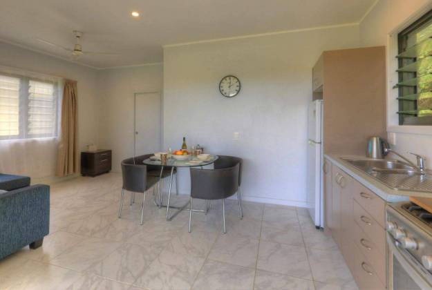 the indoor area with kitchen and four chairs with a dining table