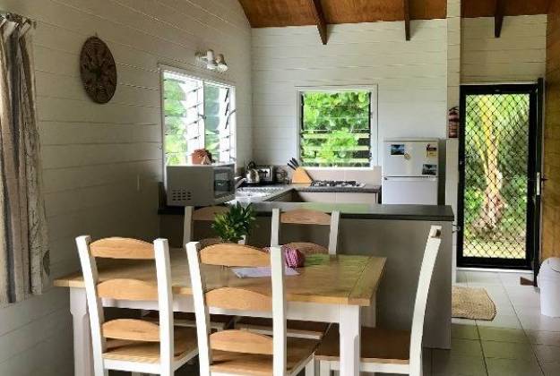 dining room with kitchen in background