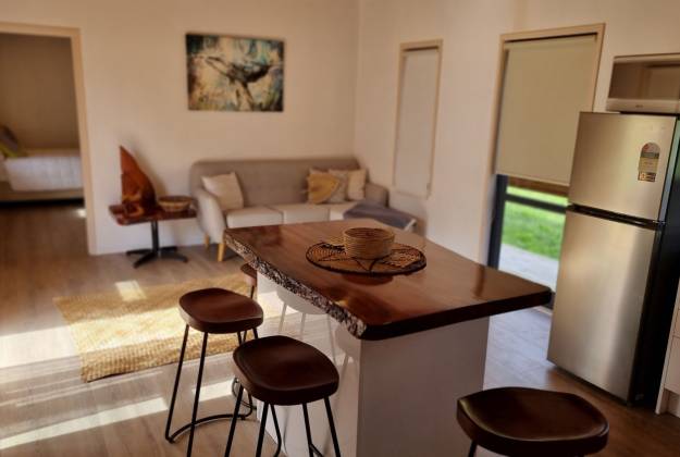 Dining area, kitchen and tables at accommodation at Tuaga Lodge