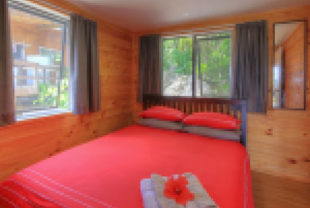 a room with a red bed spread